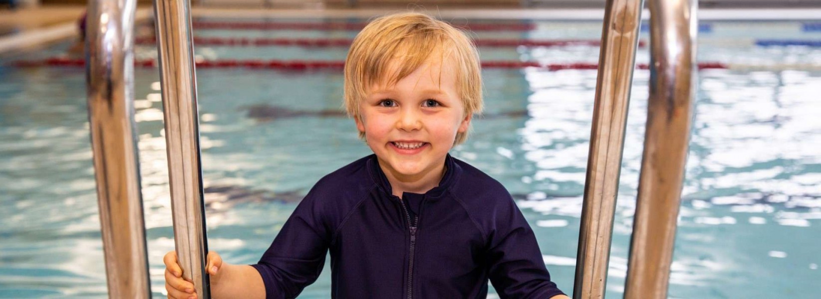 Child using the stairs to get out of the pool at RGU Sport