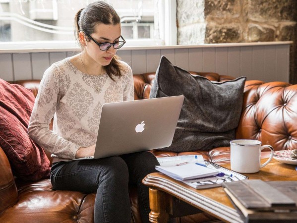 woman sitting in cafe working on laptop woman sitting in cafe working on laptop