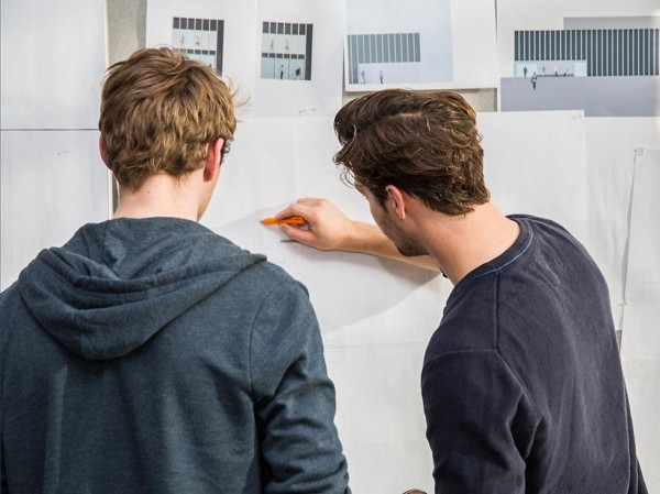 two people looking at a drawing board two people looking at a drawing board