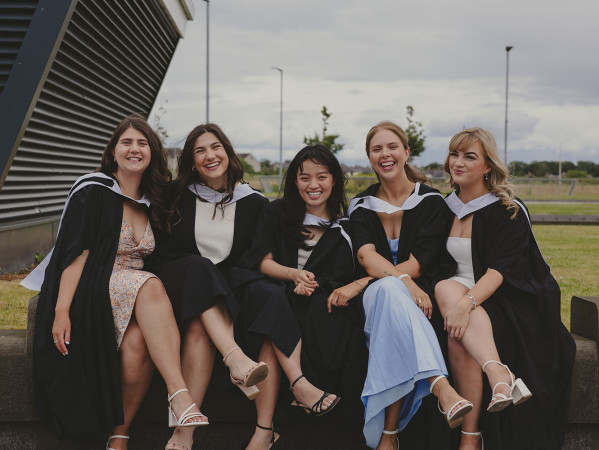 Graduates in gowns and hats Graduates in gowns and hats