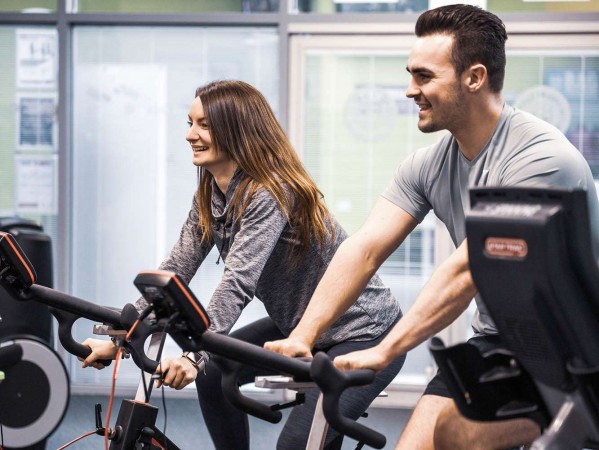 people on exercise bikes