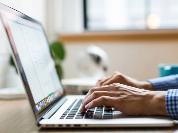 person typing on a laptop person typing on a laptop
